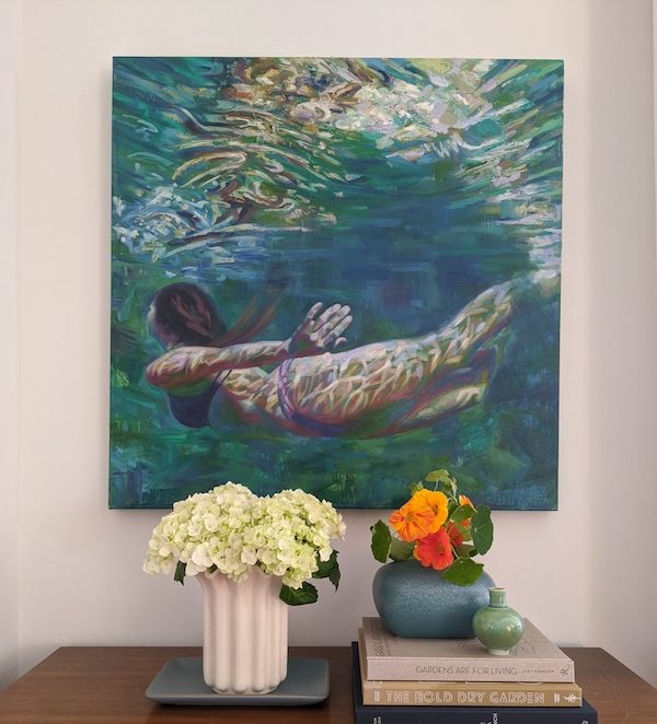 Art Piece Above Credenza of Woman Swimming In Open Water