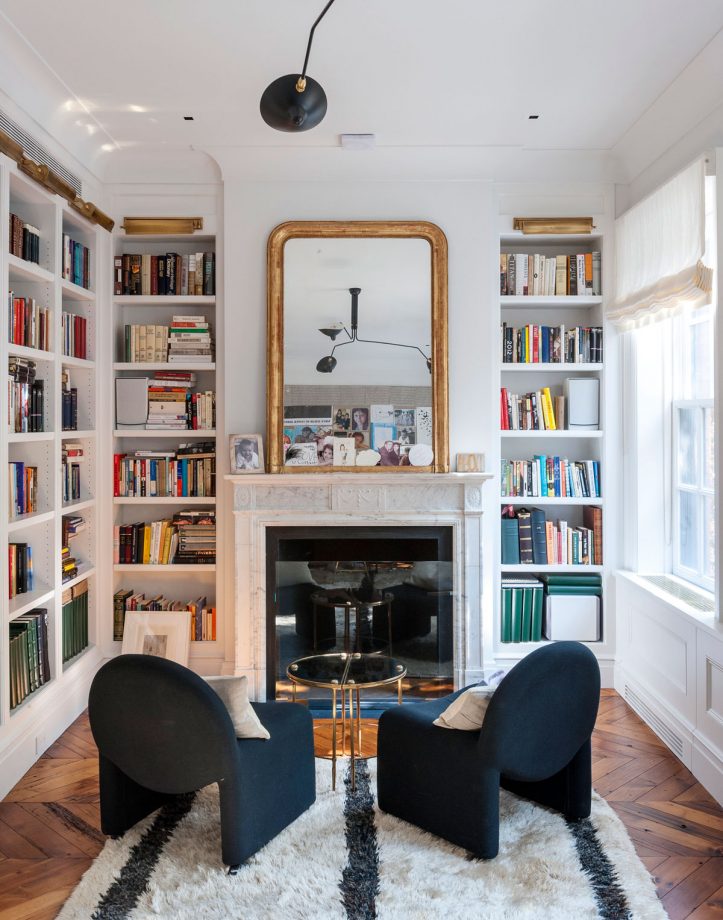 Vintage chairs in front of fireplace inside a Brownstone in New York